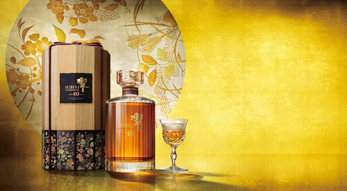 A bottle of Hibiki 40 Year Old sits in between the external box and a small dram